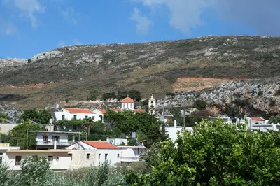 a group of houses in front of a mountain at Eliana's Stone House in Benoudhianá