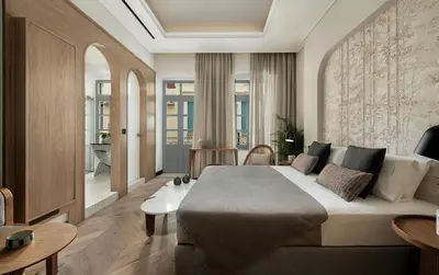 a bedroom with a large bed and a living room at Malmo Historic Hotel in Chania Town