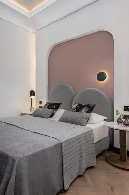 a bedroom with two beds and a large headboard at Malmo Historic Hotel in Chania Town