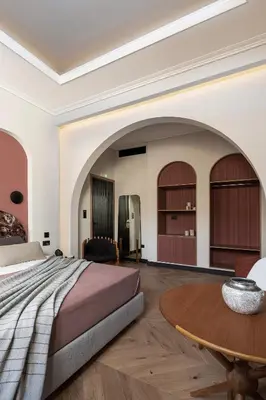 a bedroom with a bed and a wooden table at Malmo Historic Hotel in Chania Town