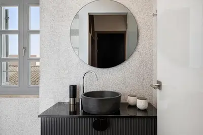 a bathroom with a sink and a mirror at Malmo Historic Hotel in Chania Town