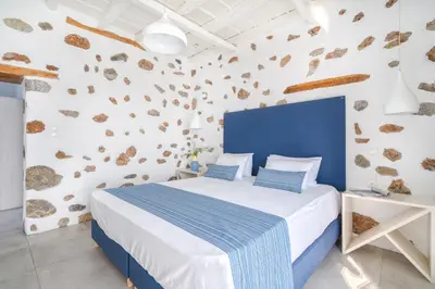 a bedroom with a blue and white wall and a bed at FantaSea Luxury Suite in Khóra Sfakíon