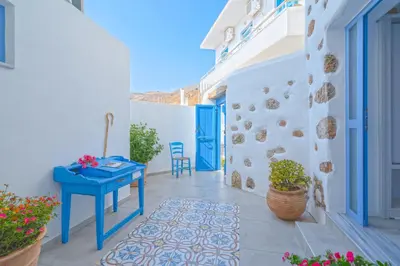 a blue table on a balcony with a blue door at FantaSea Luxury Suite in Khóra Sfakíon
