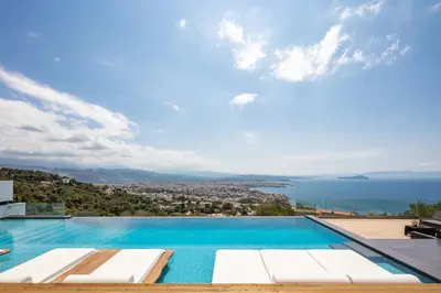 a swimming pool with a view of the ocean at Regal Residence in Chania Town