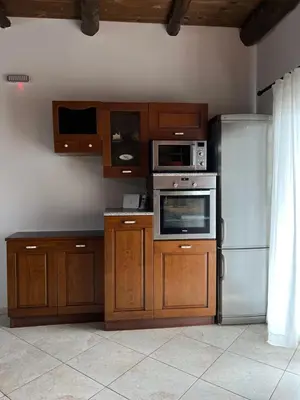 a kitchen with wooden cabinets and a refrigerator at Serenity Resort in Vrísai