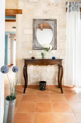 a table with a mirror on a stone wall at Beachfront villa Turquoise with private pool, BBQ and ping pong table in Chania Town