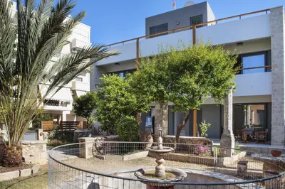 a courtyard with a fountain in front of a building at Terpsis Estate in Chania Town