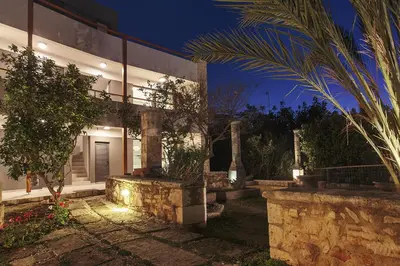 a house with a courtyard at night with lights at Terpsis Estate in Chania Town