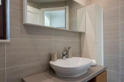 a bathroom with a white sink and a mirror at Villa Nina with Private Pool in Kolymvari