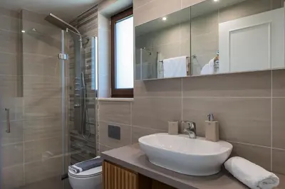 a bathroom with a sink and a shower and a toilet at Villa Nina with Private Pool in Kolymvari