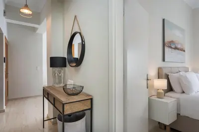 a bedroom with a bed and a table with a mirror at CALMERA Luxury Living in Chania Town