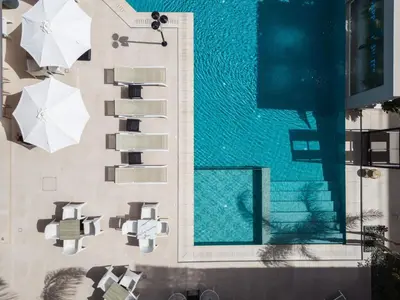 an overhead view of a swimming pool with umbrellas at Sapphire Blue Suites in Kissamos