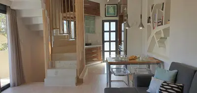 a living room with a dining room table and a kitchen at Blueonar in Chania Town