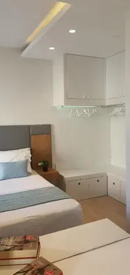 a bedroom with a bed and white cabinets at Blueonar in Chania Town