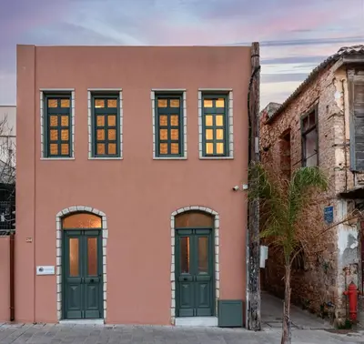 a building with green doors and windows at Estia Luxury Living in Chania Town