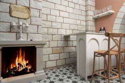 a living room with a fireplace and a table and chairs at Estia Luxury Living in Chania Town