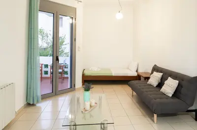 a living room with a couch and a table at Villa Krini in Kalathas