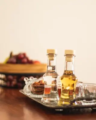 two bottles of oil and glasses on a tray at Villa Krini in Kalathas