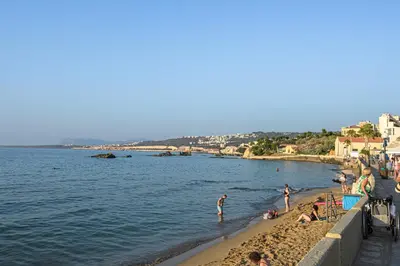 a group of people on a beach near the water at Just For Two in Chania Town