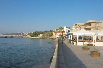a street next to a body of water with buildings at Just For Two in Chania Town