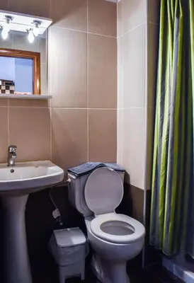 a bathroom with a toilet and a sink at Panorama Hotel in Falasarna