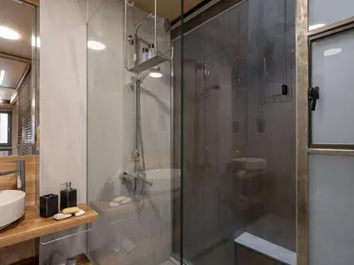 a bathroom with a shower with a glass door at Casa Sorvolou in Chania Town