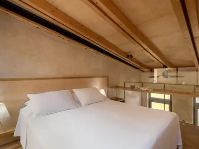 a bedroom with a white bed and a window at Casa Sorvolou in Chania Town