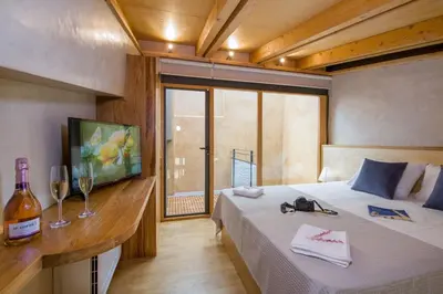 a bedroom with a bed with a bottle of wine at Casa Sorvolou in Chania Town