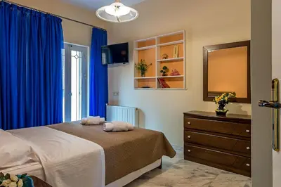 a bedroom with blue curtains and a bed and a dresser at Sea Breeze & Stunning Views - Pool Dream Gem in Dhémbla