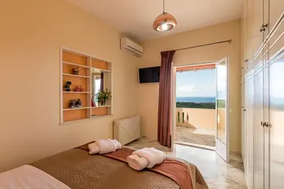 a bedroom with a bed and a view of the ocean at Sea Breeze & Stunning Views - Pool Dream Gem in Dhémbla