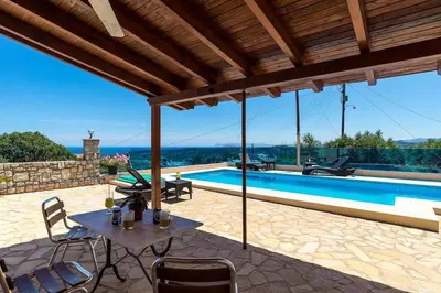 a patio with a table and chairs and a swimming pool at Sea Breeze & Stunning Views - Pool Dream Gem in Dhémbla