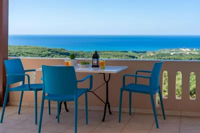 a table and chairs on a balcony with a view at Sea Breeze & Stunning Views - Pool Dream Gem in Dhémbla