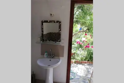 a bathroom with a sink and a mirror at Olga's traditional stone house, Palaiochora in Kondokiníyion