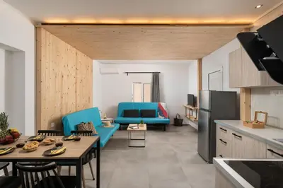 a kitchen and living room with blue chairs and a table at 