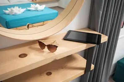 a table with a pair of glasses and a tablet at 