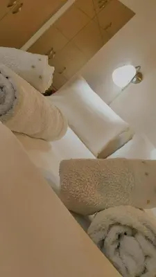 two rolled up towels sitting on a white counter at Nikis Apartment 3 in Chania Town