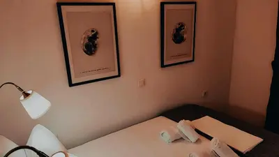 a room with a bed and two pictures on the wall at Nikis Apartment 3 in Chania Town
