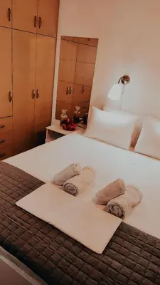a bedroom with a bed with towels on it at Nikis Apartment 3 in Chania Town