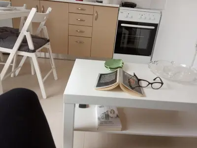 a kitchen with a table with a laptop and glasses on it at Nikis Apartment 3 in Chania Town