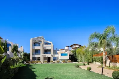 a large building with a lawn in front of it at Villa Aroma in Chania Town