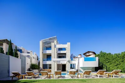 a building with tables and chairs in front of it at Villa Aroma in Chania Town