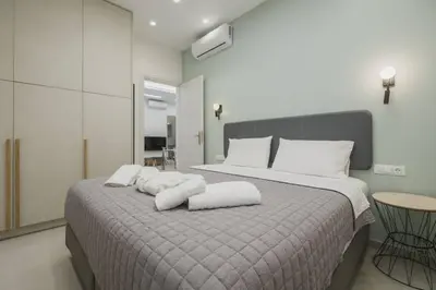 a bedroom with a large bed with white pillows at Peris 3 - Central Apt near Old Town - AC, Wifi in Chania Town