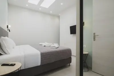a bedroom with a bed with two towels on it at Peris 3 - Central Apt near Old Town - AC, Wifi in Chania Town