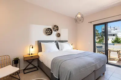 a bedroom with a bed and a desk and a window at Artemisia Residence in Chania Town