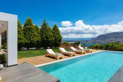 a swimming pool with lounge chairs next to a house at Artemisia Residence in Chania Town
