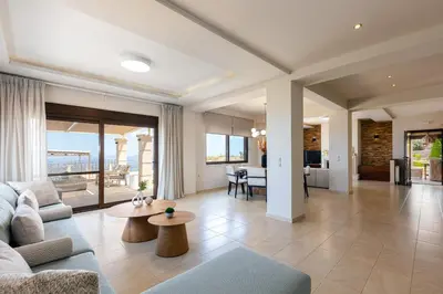 a living room with a couch and a table at Villa Golden Hill in Chania Town