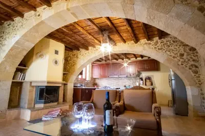 a kitchen and dining room with a table with wine glasses at Villa Styliani in Kissamos