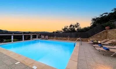 a swimming pool with two lounge chairs at Cretan Kera Villa Heated Pool in Kerá