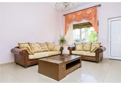 a living room with two couches and a coffee table at Andronikis House in Pithárion