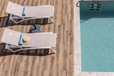 an overhead view of two tables and a swimming pool at Villa Pervoli in Varípetron